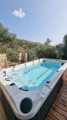 a hot tub on top of a wooden deck at INO III Domus SWIMSPA by Amigdalokefali Elafonissi in AmigdhalokeFálion