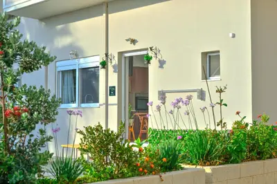 a house with flowers in front of it at Mpoulakis Apt 46 in Kissamos