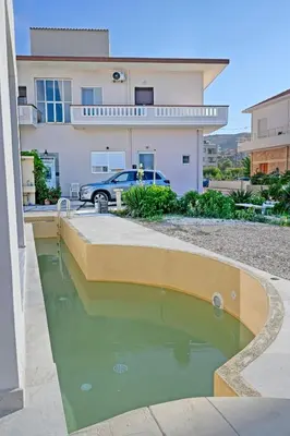 a pool of water in front of a house at Mpoulakis Apt 46 in Kissamos