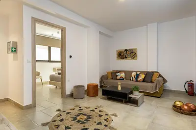 a living room with a couch and a table at Iniada Villas in Chania Town