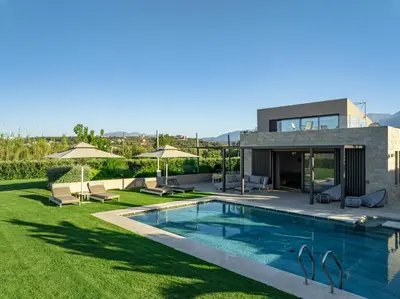 a villa with a swimming pool and a house at Iniada Villas in Chania Town