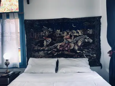 a tapestry hanging above a bed in a bedroom at DIONI 2 in Chania Town