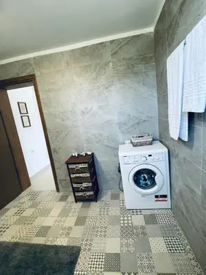 a laundry room with a washing machine in a bathroom at Haroupia in Elafonisi