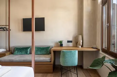 a room with a desk with a green chair at Anassa Chania Boutique Hotel in Chania Town