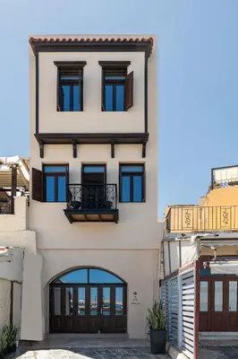 a tall white building with a door and windows at Anassa Chania Boutique Hotel in Chania Town