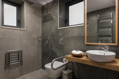 a bathroom with a sink and a toilet and a shower at Belair villas in Chania Town