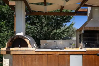 an outdoor kitchen with an outdoor pizza oven at Belair villas in Chania Town