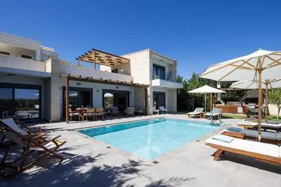 a villa with a swimming pool and a house at Belair villas in Chania Town