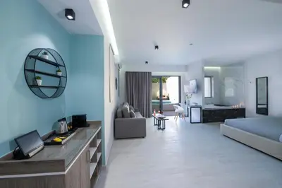 a large living room with a blue wall at xSuites - Adults Only Boutique Suites with Private Jacuzzi in Agia Marina Nea Kydonias