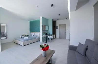a living room with a couch and a bed at xSuites - Adults Only Boutique Suites with Private Jacuzzi in Agia Marina Nea Kydonias