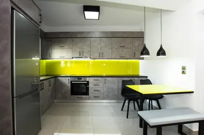 a kitchen with a table and a yellow kitchen at Villagio House in Falasarna