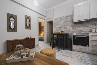 a kitchen and living room with a table and chairs at D&G Lux City Flat next to Old Town and Market in Chania Town