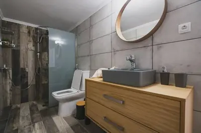 a bathroom with a sink and a toilet and a mirror at D&G Lux City Flat next to Old Town and Market in Chania Town