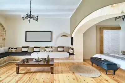 a living room with a bed and a table at Dreamscape Residences - Stavros Apartment in Chania Town