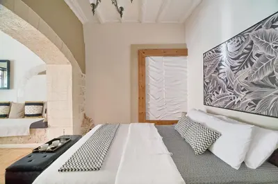 a bedroom with a large white bed and a window at Dreamscape Residences - Stavros Apartment in Chania Town