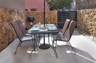 a table and four chairs with food on it at Dreamscape Residences - Stavros Apartment in Chania Town