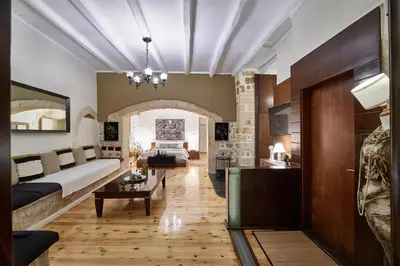 a living room with a couch and a table at Dreamscape Residences - Stavros Apartment in Chania Town