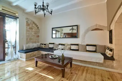 a living room with a large bed and a table at Dreamscape Residences - Stavros Apartment in Chania Town