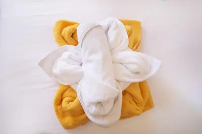 a pile of towels sitting on a table at Villa Moma in Palio Gerani