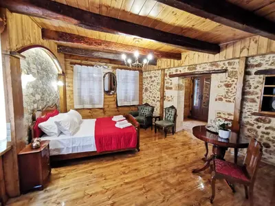 a bedroom with a bed and a table and chairs at Casa di Portou No3 in Chania Town