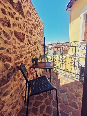 a table and chairs sitting on a balcony at Casa di Portou No3 in Chania Town