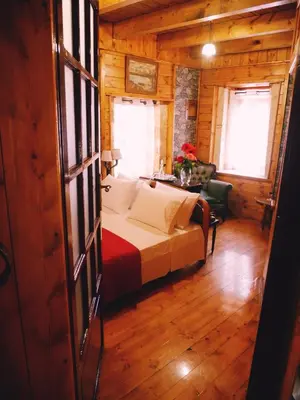 a bedroom with a bed in a wooden cabin at Casa di Portou No3 in Chania Town