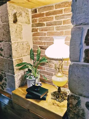 a lamp on a table next to a brick wall at Casa di Portou No3 in Chania Town