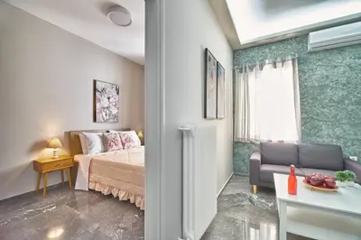 a bedroom with a bed and a couch in a room at evgenia's city apartment in Chania Town