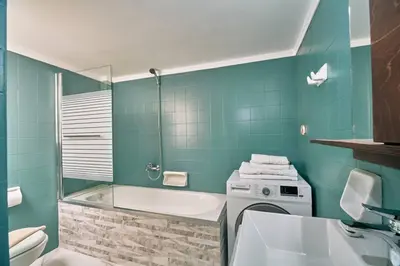 a bathroom with a tub and a toilet and a sink at evgenia's city apartment in Chania Town