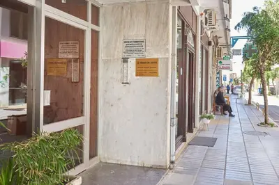 a building on the side of a street with signs on it at evgenia's city apartment in Chania Town