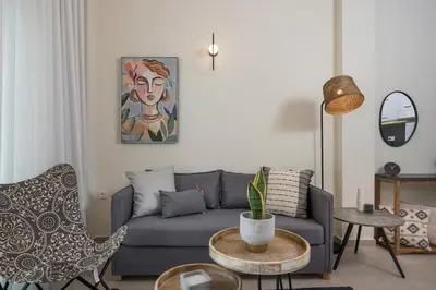 a living room with a couch and a table at Kolymbari Sea Front Cozy Apartments in Kolymvari