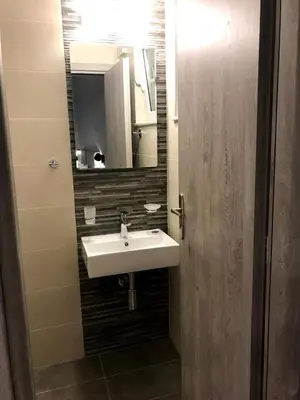 a bathroom with a sink and a mirror at Tasoula's Beachside Rooms in Palaiochóra