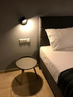 a small table next to a bed in a room at Tasoula's Beachside Rooms in Palaiochóra