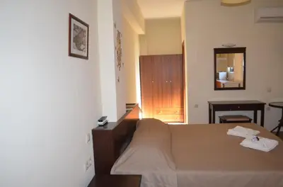 a hotel room with a bed and a mirror at Xenonas Anopolis 2 in Anopoli Sfakion
