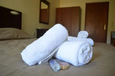 a pile of towels on top of a bed at Xenonas Anopolis 2 in Anopoli Sfakion