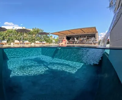 a swimming pool with blue water in a resort at Eleanthi Modern Living in Galatás