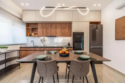 a kitchen with a table and chairs and a refrigerator at Margiani Studio & Apartment in Chania Town