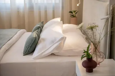 a pile of pillows on a bed in a room at Margiani Studio & Apartment in Chania Town