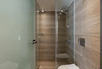 a bathroom with a toilet and a glass shower at Margiani Studio & Apartment in Chania Town