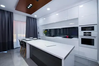 a white kitchen with a large white counter top at TWIN'S HOME LUXURY SUITES in Alikianós