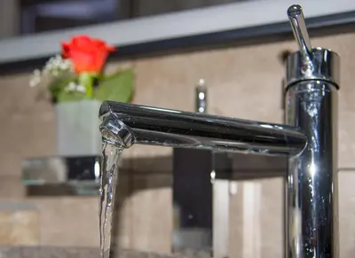 a water fountain with a red rose in the background at TWIN'S HOME LUXURY SUITES in Alikianós