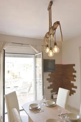 a dining room with a table and white chairs at Casa de Campo 2 in Almirida