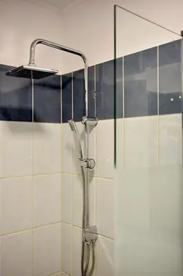 a shower with a shower head in a bathroom at Casa de Campo 2 in Almirida