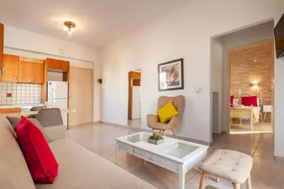 a living room with a couch and a table at jenny's flat near the sea in Galatás