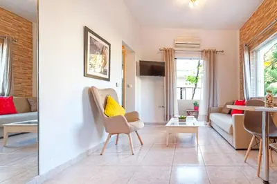 a living room with a couch and a table at jenny's flat near the sea in Galatás