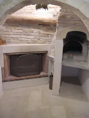 a brick fireplace with a stone oven in a room at Patriko Traditional Stone Houses in Vafés