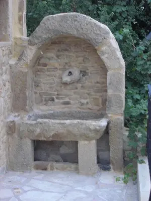 a stone oven with a face on top of it at Patriko Traditional Stone Houses in Vafés