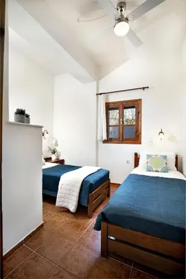 a bedroom with two beds and a window at Villa Zoi Tzitzifes in Tzitzifés