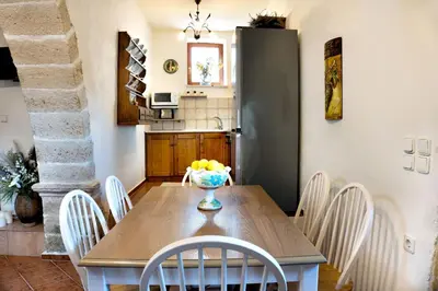 a kitchen and dining room with a table and chairs at Villa Zoi Tzitzifes in Tzitzifés