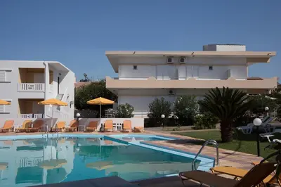 a large swimming pool in front of a building at Elena Rooms & Apartments in Gerani Chanion